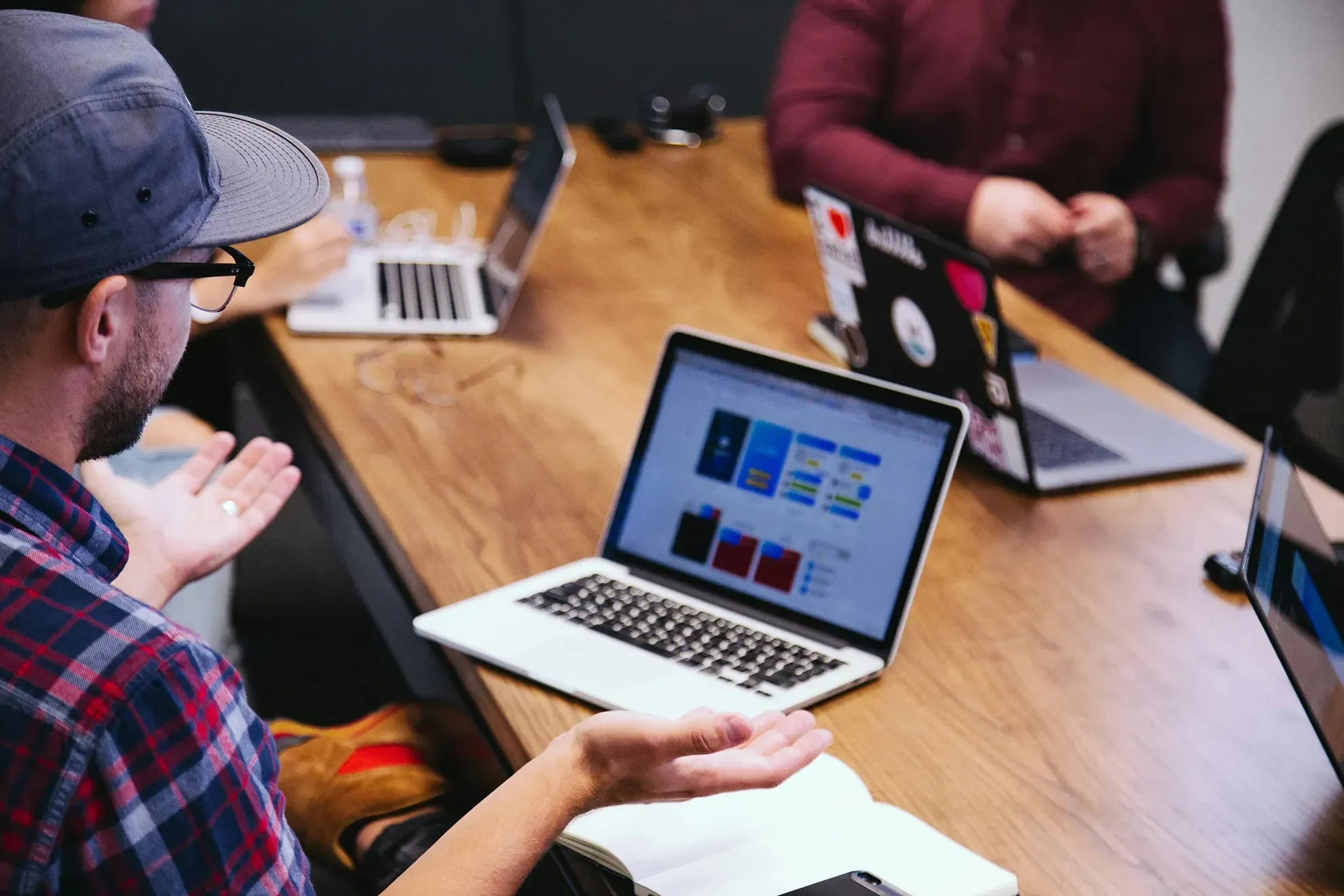 A marketing team discussing a potential website redesign project at a conference table.